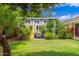 Charming shed features a bright yellow door, several windows, and is surrounded by lush landscaping at 2219 W Catalina Dr, Phoenix, AZ 85015