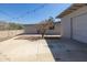 Backyard patio area with detached garage and desert landscaping, illuminated by string lights at 2346 E Sylvia St, Phoenix, AZ 85022