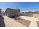 Private backyard featuring mature tree, concrete and brick patio, detached garage, and string lights at 2346 E Sylvia St, Phoenix, AZ 85022