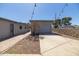 Detached garage with a backyard featuring brick and concrete patio and mature landscaping at 2346 E Sylvia St, Phoenix, AZ 85022