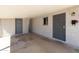 Exterior view of the carport featuring two gray doors and security gate with a decorative flower pot at 2346 E Sylvia St, Phoenix, AZ 85022