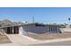 Front and side view of single-story home with gray stucco and a covered parking area on a sunny day at 2346 E Sylvia St, Phoenix, AZ 85022