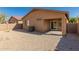 Spacious backyard with gravel, partial patio, and block fence offering privacy at 44188 W Cydnee Dr, Maricopa, AZ 85138