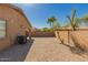 Desert backyard with block wall, desert landscaping, and palm trees in the background at 44188 W Cydnee Dr, Maricopa, AZ 85138