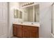 Bathroom featuring a double vanity, large mirror and lots of lighting at 44188 W Cydnee Dr, Maricopa, AZ 85138