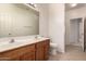 Bathroom featuring a double sink vanity, a large mirror, and tile flooring at 44188 W Cydnee Dr, Maricopa, AZ 85138