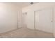 Spacious bedroom with white walls, carpet, closet with sliding doors, and an open doorway at 44188 W Cydnee Dr, Maricopa, AZ 85138