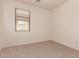 Bedroom featuring neutral carpet flooring, white walls, and a window at 44188 W Cydnee Dr, Maricopa, AZ 85138
