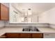 Bright kitchen with stainless steel double sink and pass through to living area at 44188 W Cydnee Dr, Maricopa, AZ 85138