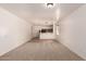 Spacious living area with carpeted floors and open access to a kitchen area at 44188 W Cydnee Dr, Maricopa, AZ 85138