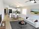 Bright living room showcases a modern design with a white sofa, stylish coffee table, and dining area at 4582 E Superior Rd, Queen Creek, AZ 85143