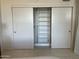 A bright white closet with sliding doors and open shelving for ample storage at 535 W Thomas Rd # 407, Phoenix, AZ 85013