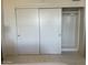 A bright white closet with sliding doors and rod for clothing at 535 W Thomas Rd # 407, Phoenix, AZ 85013