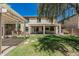 Expansive backyard with covered patio, built-in barbecue, and lush landscaping at 10945 E Storia Ave, Mesa, AZ 85212