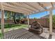 Backyard with a pergola-covered fountain and landscaped garden at 10945 E Storia Ave, Mesa, AZ 85212