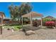 Lush backyard with decorative pergola and water feature creates serene outdoor space at 10945 E Storia Ave, Mesa, AZ 85212