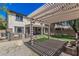Beautiful backyard featuring a pergola, covered patio, and manicured lawn at 10945 E Storia Ave, Mesa, AZ 85212