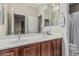 Bathroom features a double sink with a large mirror and cabinets with views of other rooms at 10945 E Storia Ave, Mesa, AZ 85212