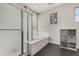 Bathroom with tiled floors, a corner tub, glass door shower, and lots of natural light at 10945 E Storia Ave, Mesa, AZ 85212