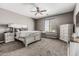 This bedroom offers carpet flooring, a ceiling fan, and lots of space for the perfect setup at 10945 E Storia Ave, Mesa, AZ 85212