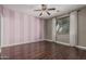 Bedroom features hardwood floors, a ceiling fan, and windows bringing in natural light at 10945 E Storia Ave, Mesa, AZ 85212