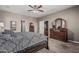 Primary bedroom features a ceiling fan, carpet and two-door access to the rest of the house at 10945 E Storia Ave, Mesa, AZ 85212