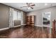 Spacious bonus room with hardwood floors, bookshelves, and a ceiling fan is a great flex space at 10945 E Storia Ave, Mesa, AZ 85212
