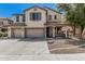 Charming two-story home featuring a spacious three-car garage and inviting front porch at 10945 E Storia Ave, Mesa, AZ 85212
