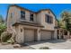 Spacious two-story home with a three-car garage, inviting porch, and manicured landscaping at 10945 E Storia Ave, Mesa, AZ 85212