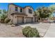 Spacious two-story home with a three-car garage, inviting porch, and manicured landscaping at 10945 E Storia Ave, Mesa, AZ 85212