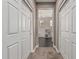 Hallway with carpet flooring between two white bi-fold doors offers tons of storage at 10945 E Storia Ave, Mesa, AZ 85212