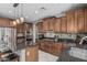 Well-appointed kitchen showcasing granite countertops, wood cabinetry, and stainless steel appliances at 10945 E Storia Ave, Mesa, AZ 85212