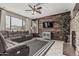 Inviting living room featuring a stone fireplace, wood accent wall and comfortable, oversized leather seating at 10945 E Storia Ave, Mesa, AZ 85212