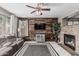 Comfortable living room with a fireplace, wood accent wall, and modern decor at 10945 E Storia Ave, Mesa, AZ 85212