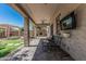 Inviting covered patio with outdoor seating and mounted television for relaxation at 10945 E Storia Ave, Mesa, AZ 85212