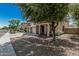 Inviting home exterior with a covered porch and mature trees shading the landscaped front yard at 10945 E Storia Ave, Mesa, AZ 85212