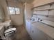 Functional bathroom with a shower, toilet, sink, and washer/dryer at 112 S 28Th Dr, Phoenix, AZ 85009