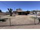 Exterior front view of a single-story home featuring a chain-link fence and sparse landscaping at 112 S 28Th Dr, Phoenix, AZ 85009