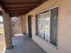 Exterior front porch showcasing a secure metal door and a large window at 112 S 28Th Dr, Phoenix, AZ 85009
