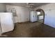 Kitchen area with appliances and an arched entrance at 112 S 28Th Dr, Phoenix, AZ 85009