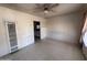 Vacant living room featuring tile flooring, a ceiling fan, and neutral walls at 112 S 28Th Dr, Phoenix, AZ 85009