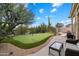 Private backyard features a putting green, desert landscaping and patio seating, perfect for recreation at 11448 E Blue Sky Dr, Scottsdale, AZ 85262