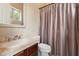 Well-lit bathroom features a neutral color palette, elegant fixtures, and a shower with curtain at 11448 E Blue Sky Dr, Scottsdale, AZ 85262