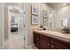 Bathroom with a dark wood vanity and tile floors, adjacent to a bedroom with neutral colors at 11448 E Blue Sky Dr, Scottsdale, AZ 85262