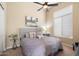 Relaxing bedroom with a comfy bed, soft lighting, and a modern ceiling fan for added comfort at 11448 E Blue Sky Dr, Scottsdale, AZ 85262