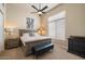 Bright bedroom featuring a queen bed, a ceiling fan, and a large window with lots of natural light at 11448 E Blue Sky Dr, Scottsdale, AZ 85262