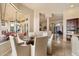 Tasteful dining area with large windows that overlook the pool area with elegant columns, perfect for entertaining guests at 11448 E Blue Sky Dr, Scottsdale, AZ 85262