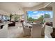 Bright dining area with large windows, stylish furniture, and access to the outdoor area, creating a perfect space at 11448 E Blue Sky Dr, Scottsdale, AZ 85262