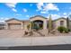 Lovely single-story home with a desert landscape, driveway to three-car garage, and a beautiful sky at 11448 E Blue Sky Dr, Scottsdale, AZ 85262
