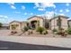 Tan single-story home with well-manicured desert landscaping and a tile roof at 11448 E Blue Sky Dr, Scottsdale, AZ 85262